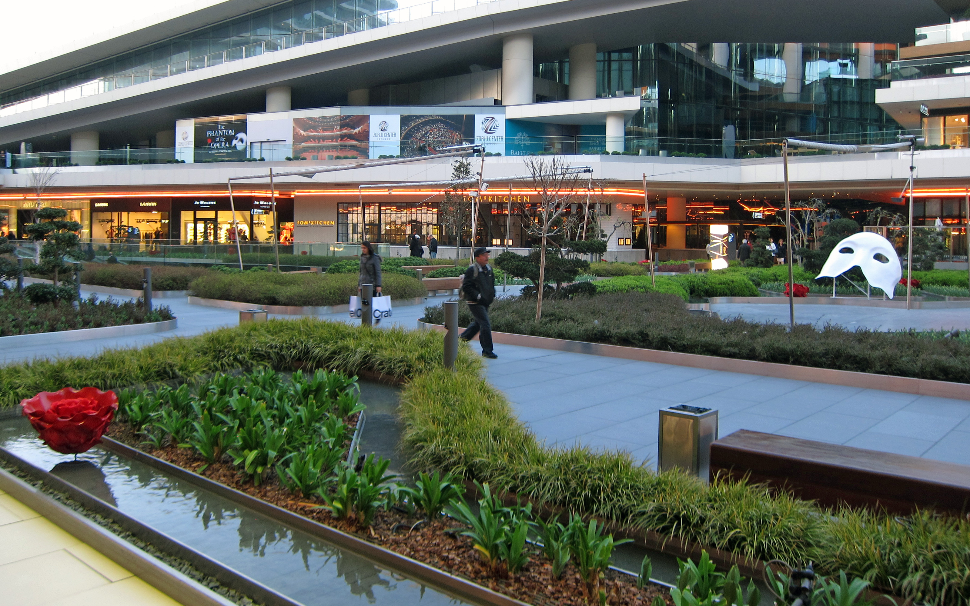 A shopping mall with about 180 stores was arranged around the main square. Shopping mall with plant beds and water features